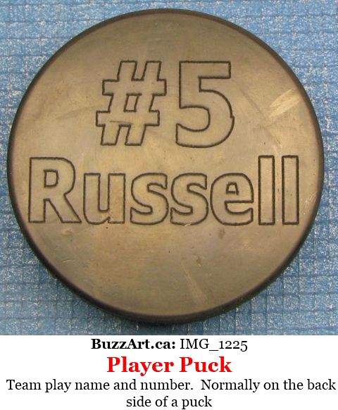Team play name and number.  Normally on the back side of a puck